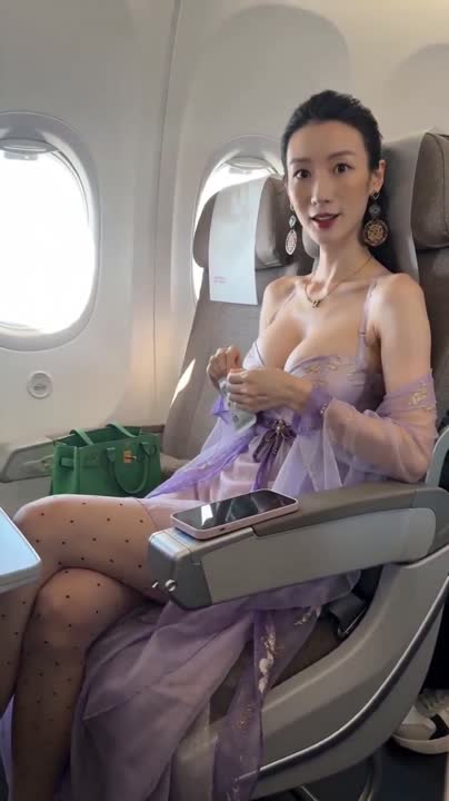 Seedance 2.0 Prompt: iPhone Handheld Airplane Cabin Video with Asian Woman
